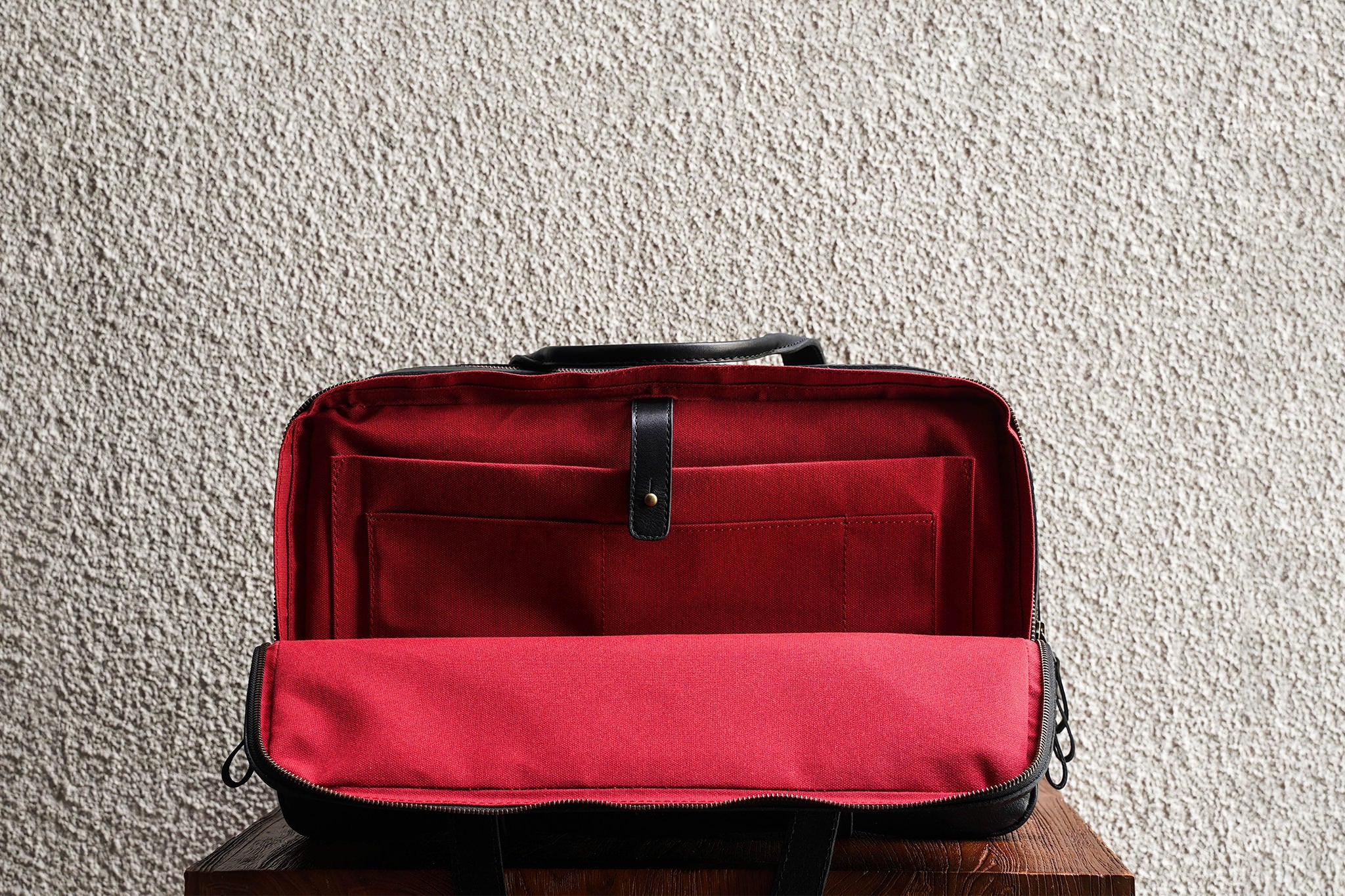 Laptop slot, 2 open pockets, and 1 pen slot in the back compartment.