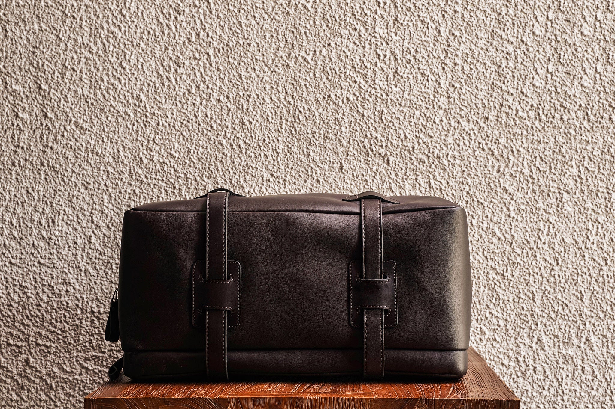 One of our signature design cues, the body straps go all around the bag, providing a load bearing structure for the bag. A big piece of leather on the bottom adds to the durability of the bag.