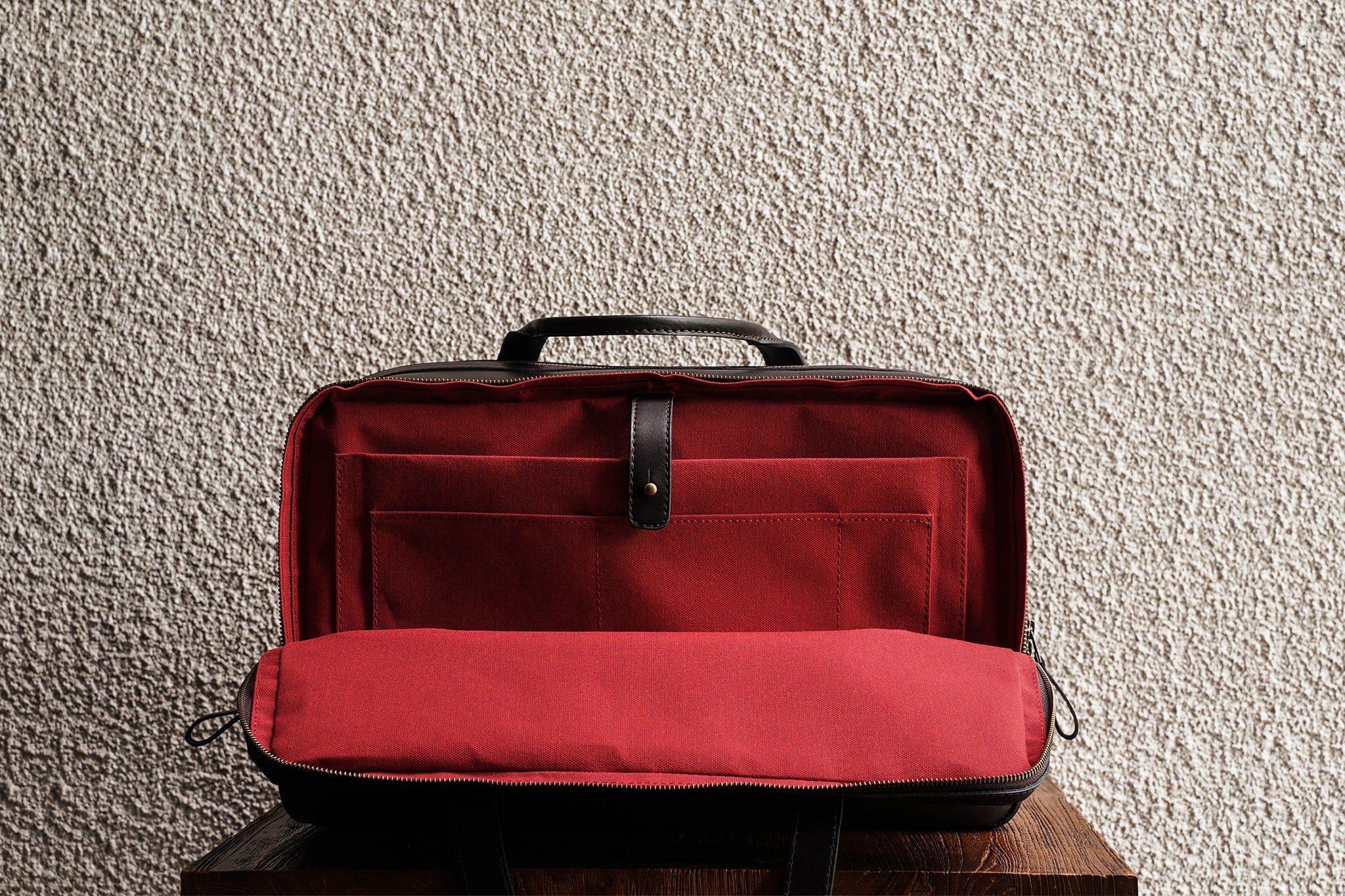 Laptop slot, 2 open pockets, and 1 pen slot in the back compartment.