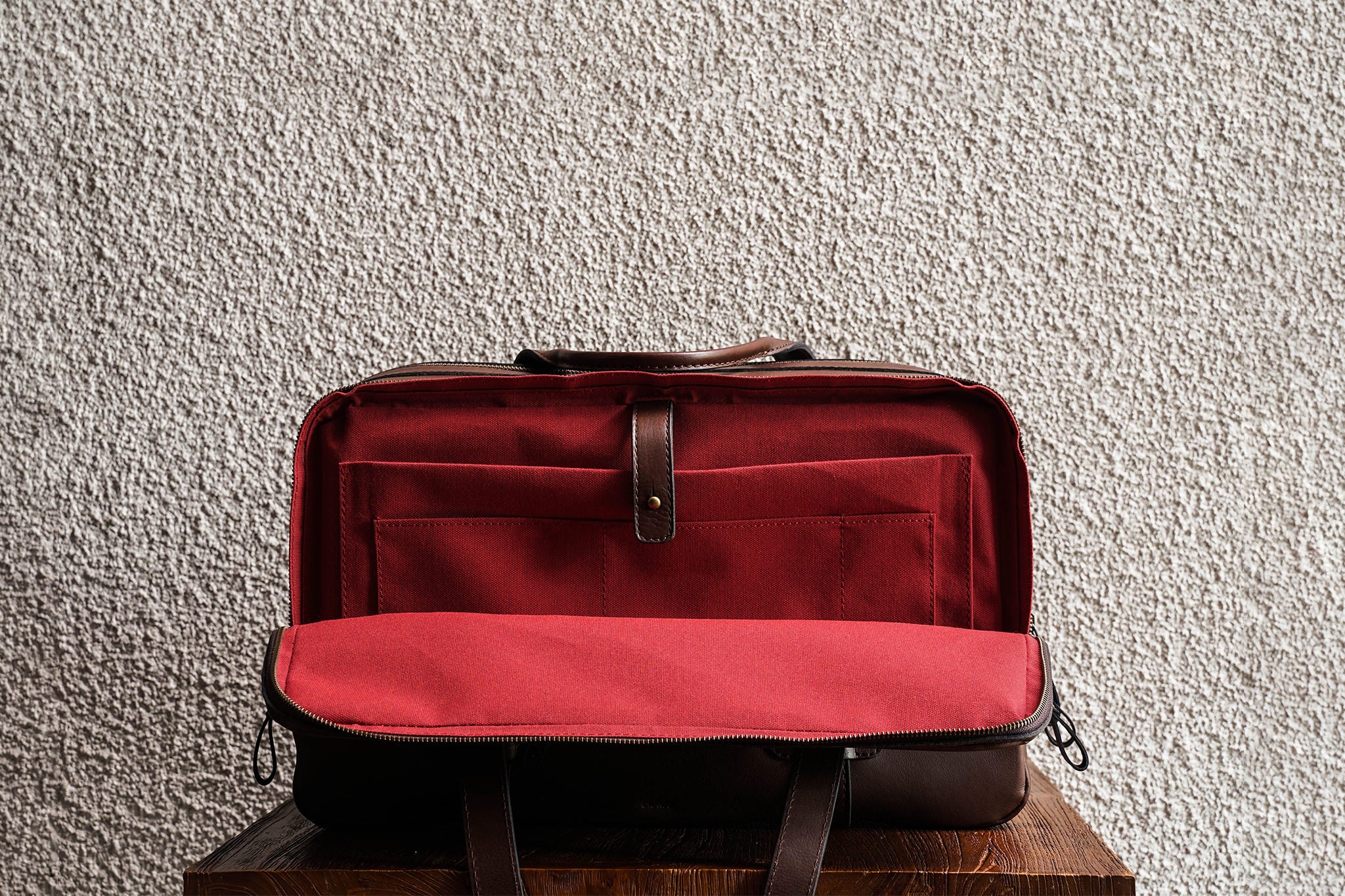 Laptop slot, 2 open pockets, and 1 pen slot in the back compartment.