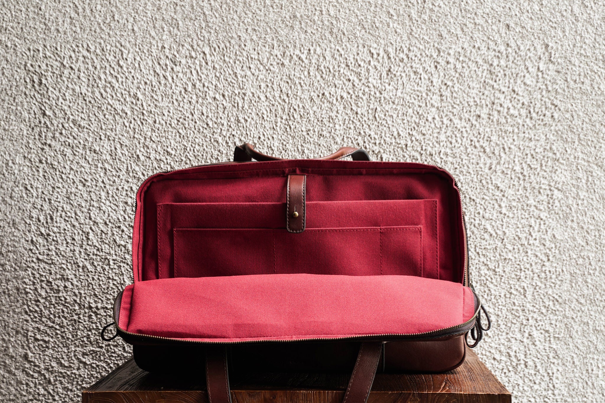 Laptop slot, 2 open pockets, and 1 pen slot in the back compartment.