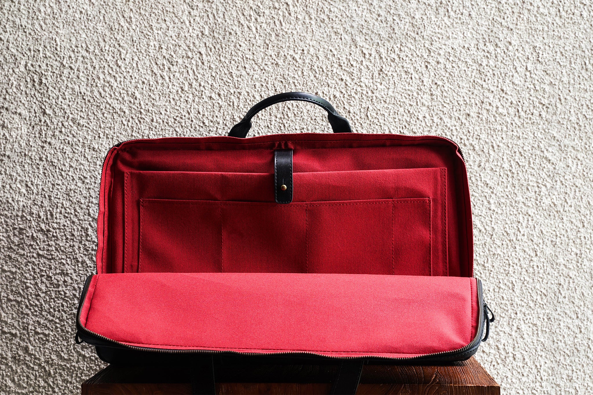 Laptop slot, 3 open pockets, and 1 pen slot in the back compartment.
