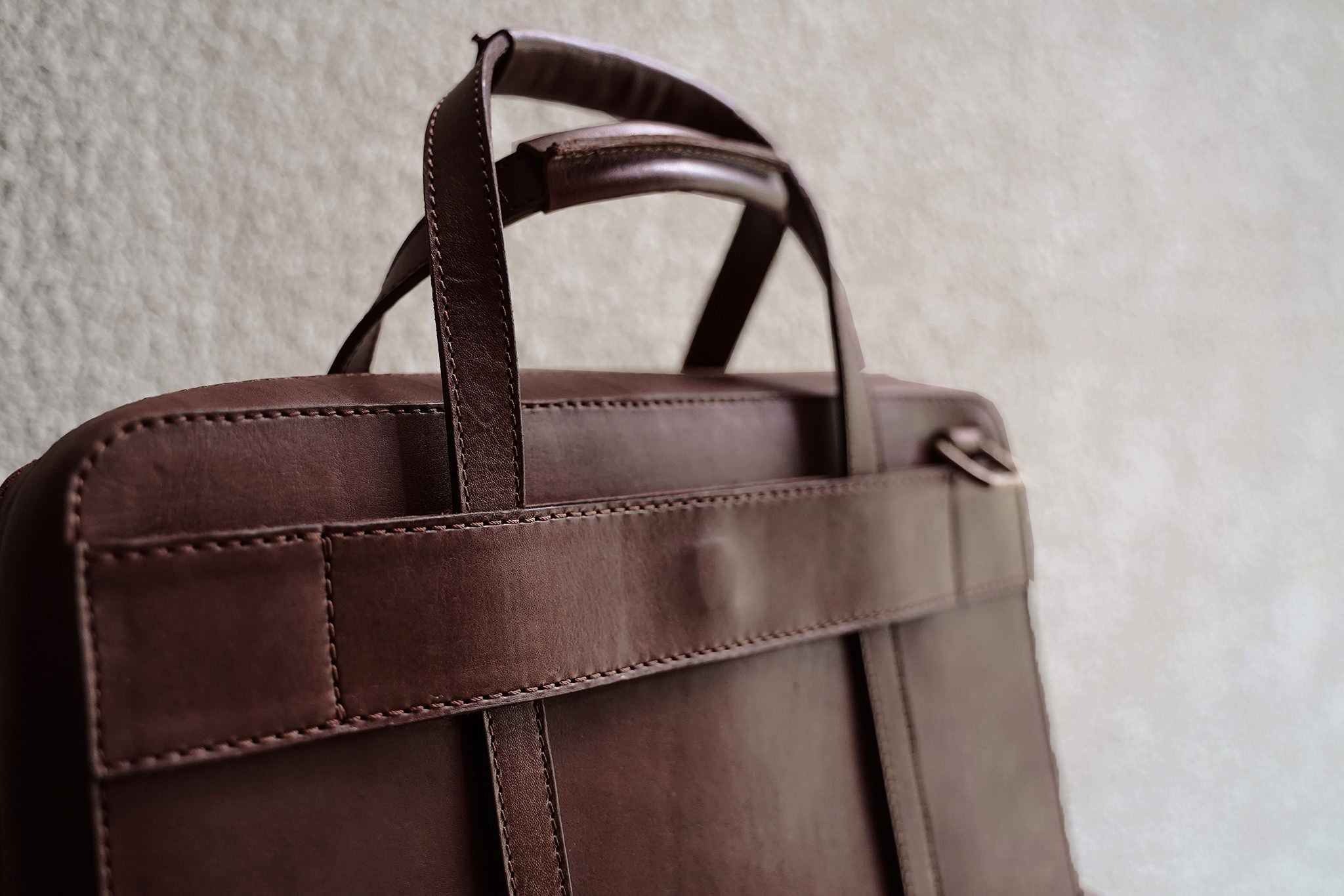 Full width back pocket underneath the luggage handle slot.