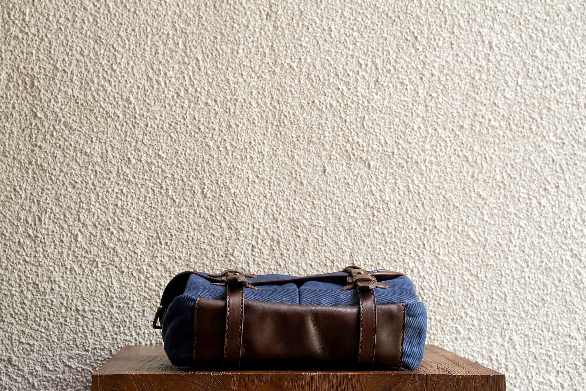One of our signature design cues, the body straps go all around the bag, providing a load bearing structure for the bag. A big piece of leather on the bottom adds to the durability of the bag.